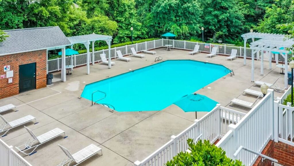 Aerial view of pool next to trees at Heritage Apartments in Orange County, NC.