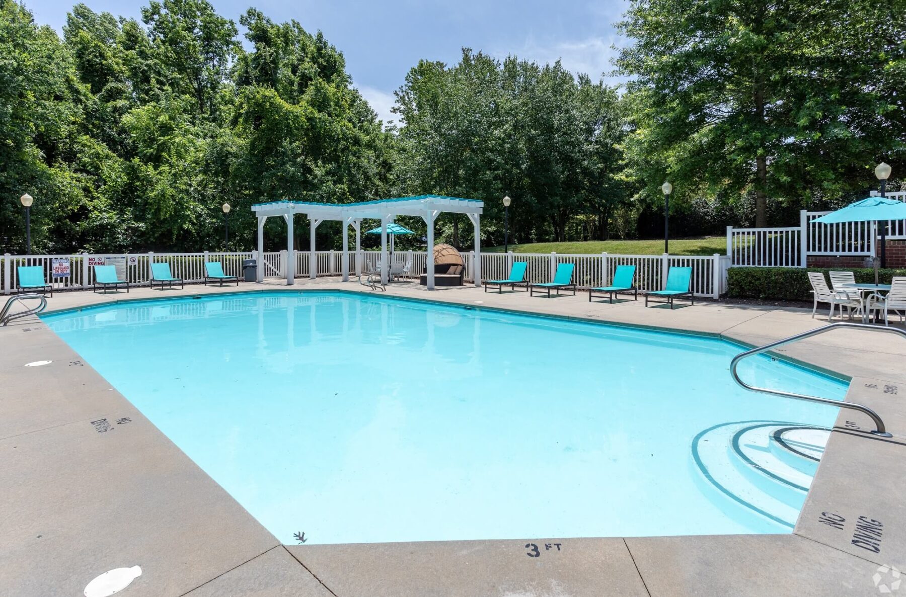 Pool with outdoor patio space and lounge chairs