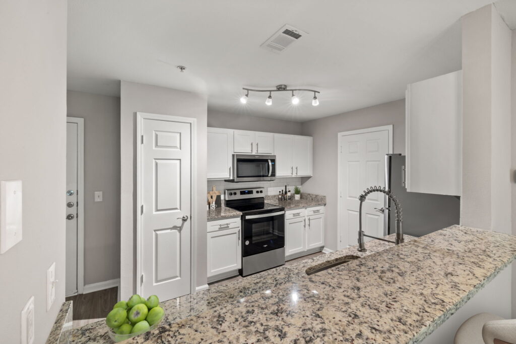 Wrap around kitchen with stainless steel appliances at Heritage Apartments for rent in Hillsborough, NC.